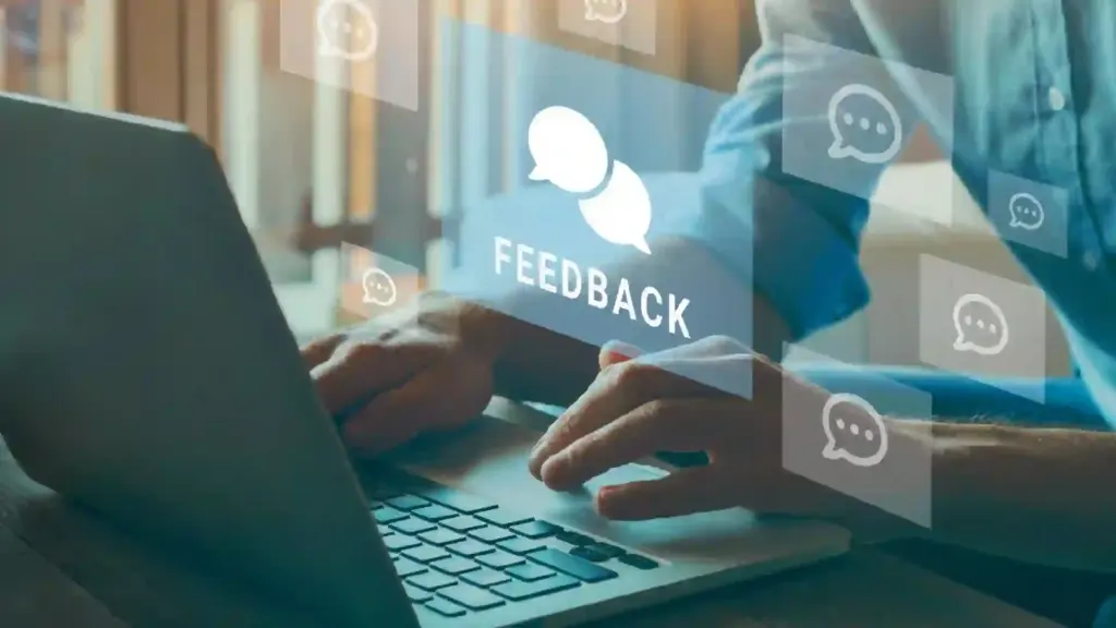 Hands typing on a laptop with translucent chat bubbles and the word FEEDBACK, signaling online feedback interaction.