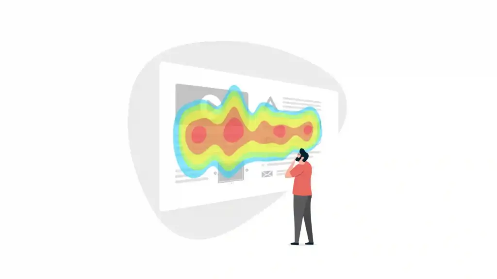 Person standing to the right analyzes a large screen displaying a multicolored heat map.
