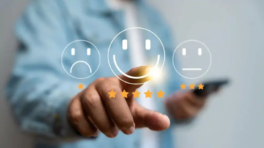 Hand taps a glowing happy face on a digital rating interface with five orange stars, symbolizing customer feedback.