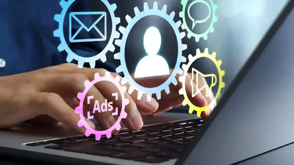 Hands typing on a laptop with colorful gears and icons symbolizing digital settings and automation