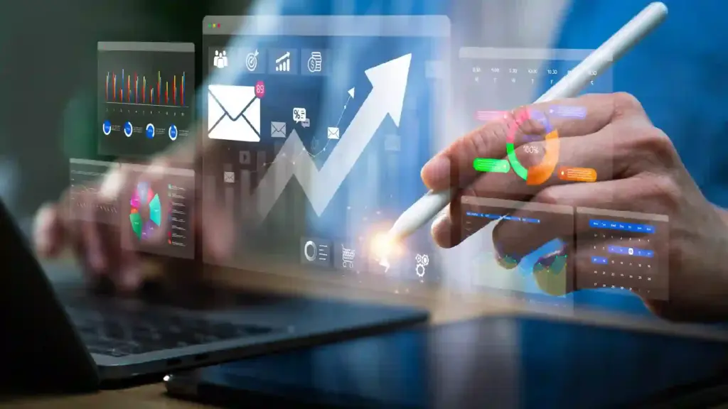 Person uses a stylus to interact with floating data dashboards and charts above a laptop screen.
