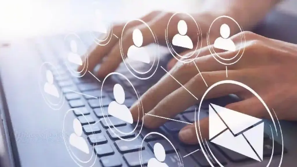 Hands typing on a laptop keyboard with floating network icons and an email envelope, illustrating digital communication and networking.
