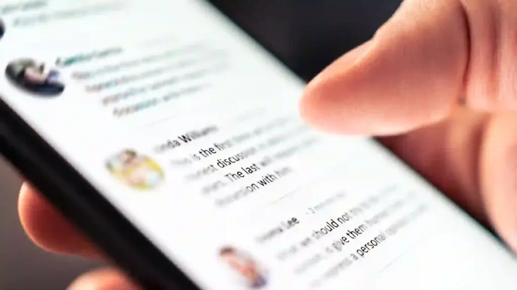 Person's finger scrolling through a text article on a smartphone screen