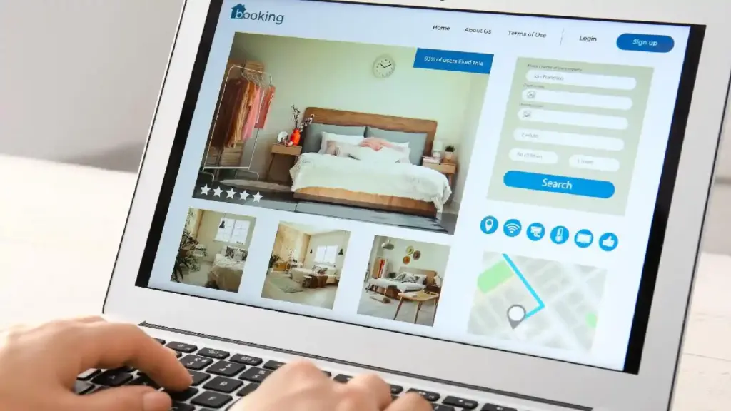Laptop screen displaying an online furniture store: bedroom photo, five-star rating, and a right-side booking form.